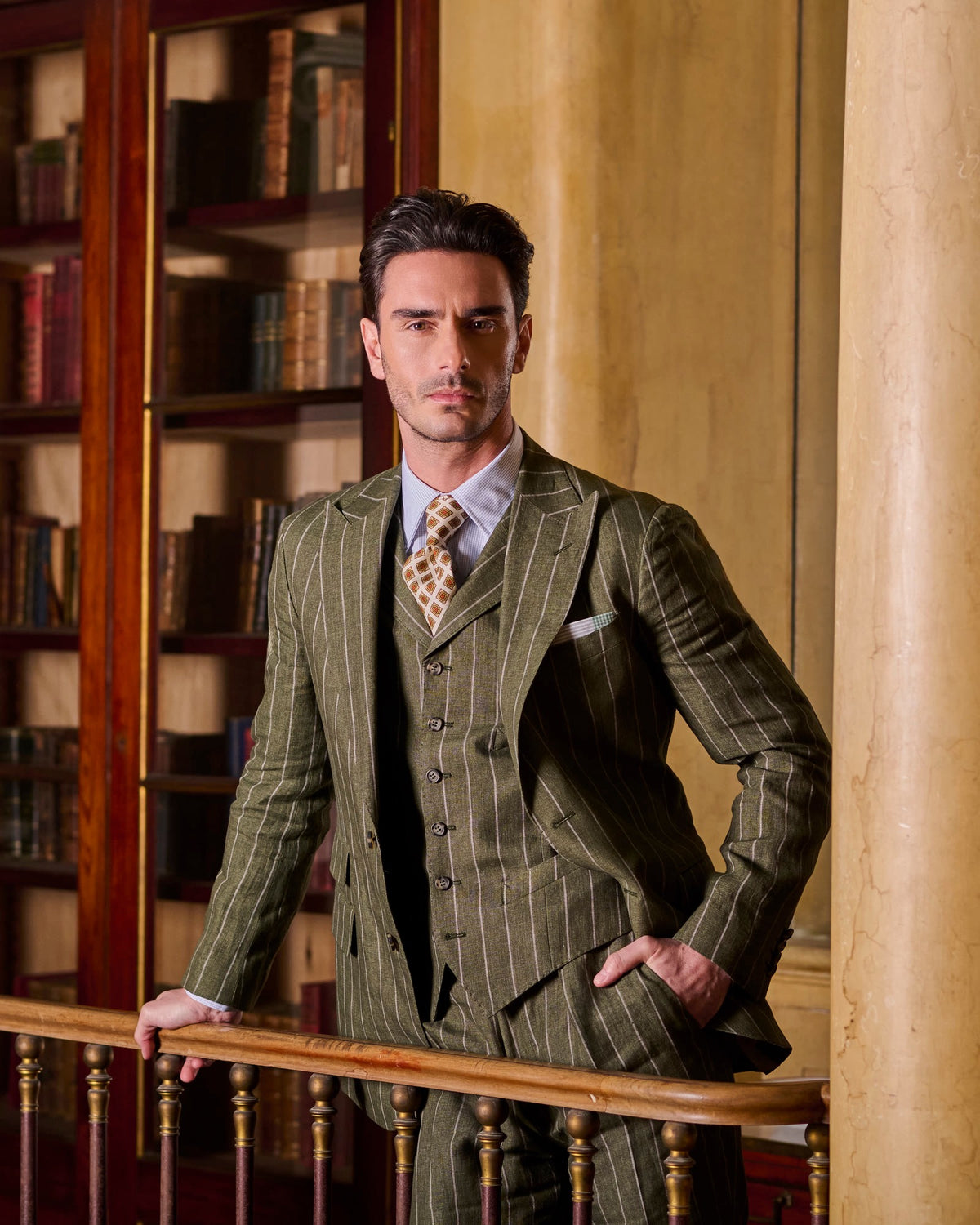 Green striped three-piece suit in a library