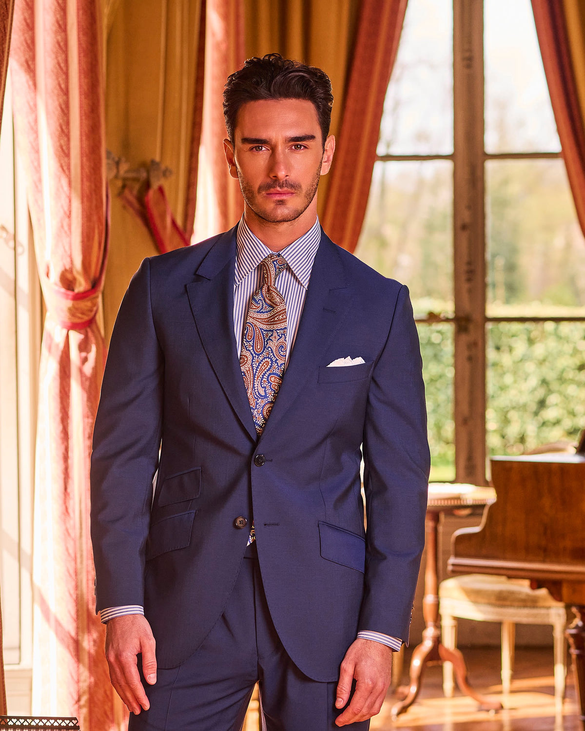 Royal blue Kensington suit in a drawing room
